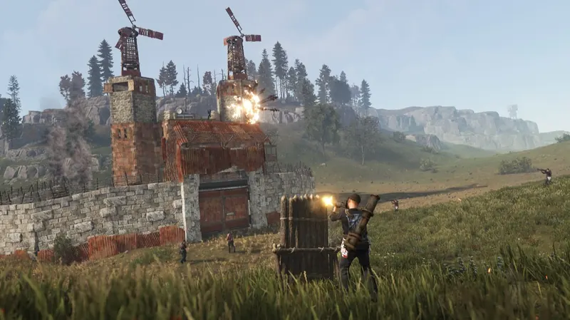 A stone compound with two tall towers being hit by rockets from a player behind a wooden barricade